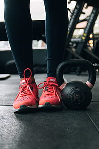 person standing beside black kettle bell thumbnail