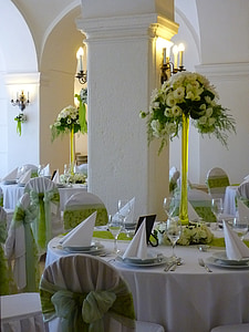white petaled flowers on table with plates and glasses thumbnail