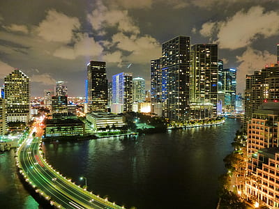 concrete bridge surrounded high-rise buildings at nighttime thumbnail