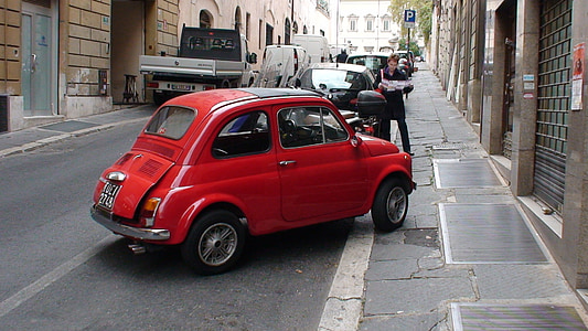 red Volkswagen Beetle coupe parked at the road thumbnail