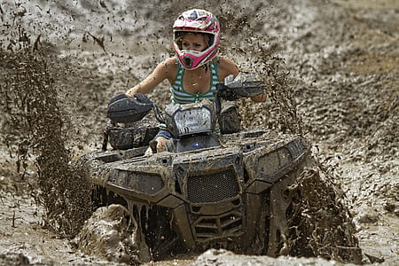 woman riding gray ATV thumbnail