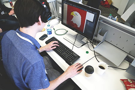 person in blue collared t-shirt using computer thumbnail