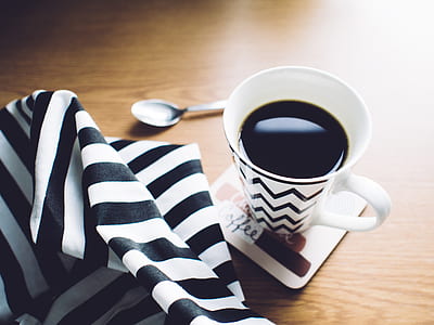 white ceramic cup with coffee beside spoon thumbnail