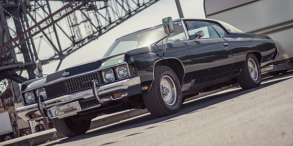 black muscle car inside parking garage thumbnail