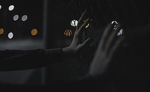 person touching cyclone wire thumbnail