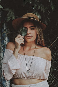 woman holding leaf on front of plants thumbnail