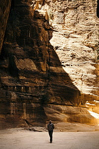 man standing near rock formation thumbnail