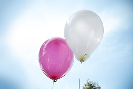 two pink and white balloons low angle photography thumbnail