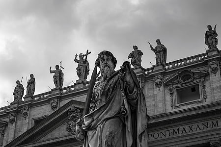 photo of gray concrete statue of man under white clouds at daytime thumbnail
