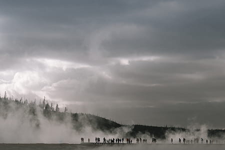 people walking with steam near mountain thumbnail