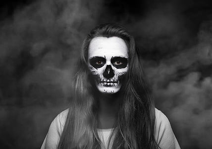 woman in black top with skull face paint thumbnail