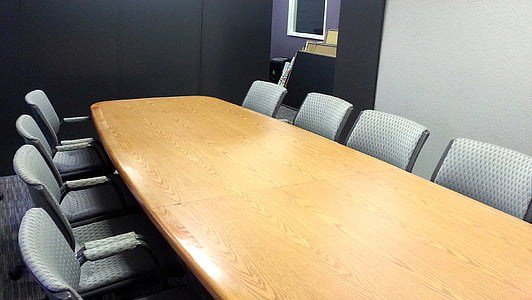 empty gray chairs with brown long table thumbnail