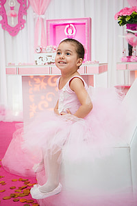 smiling girl sitting on white chair thumbnail