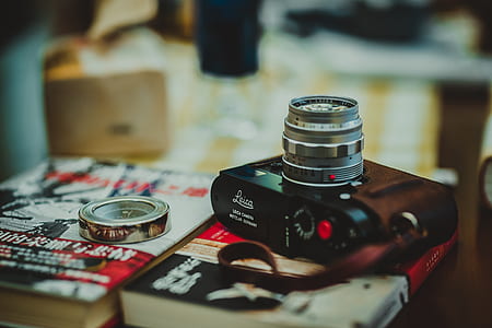 selective photography of black compact camera near silver-colored ring thumbnail