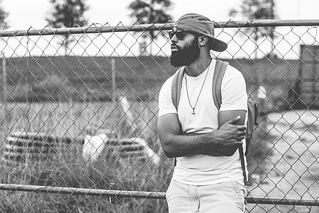 man leaning on chain link fence thumbnail