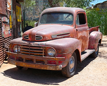 vintage brown Ford pickup truck park near galvanize sheet stall thumbnail