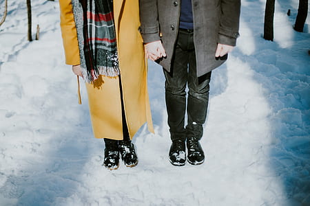 man and woman standing on snows thumbnail