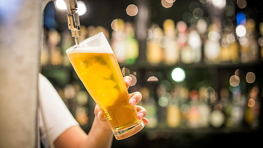 filling high ball glass with yellow beverage thumbnail