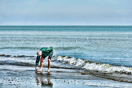 person standing on seashore thumbnail