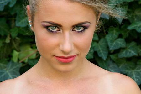 smiling woman wearing pink lipstick near green leafed plant thumbnail