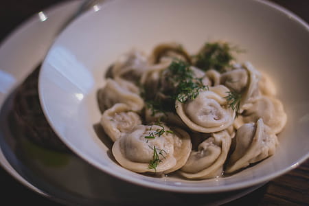 Cooked Dumplings in White Ceramic Bowl thumbnail