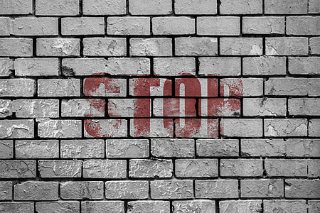 gray bricked wall with red STOP painting thumbnail