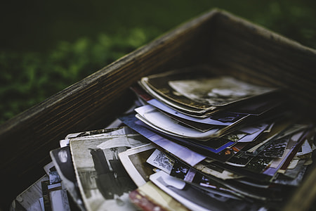 tilt shift photo of assorted photos in brown wooden storage box thumbnail
