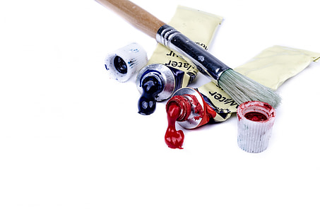 brown paintbrush on two red and black paint soft-tubes thumbnail