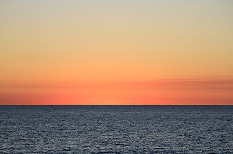 calm blue ocean during sunset thumbnail