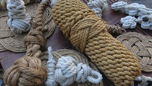 several assorted-color rolled hemp ropes on wooden surface thumbnail