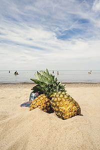 two pineapple fruits in front of seashore thumbnail