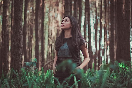 girl looking up in the middle of forest thumbnail