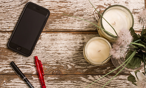 space gray iPhone 6 beside of black and blue ballpoint pens thumbnail