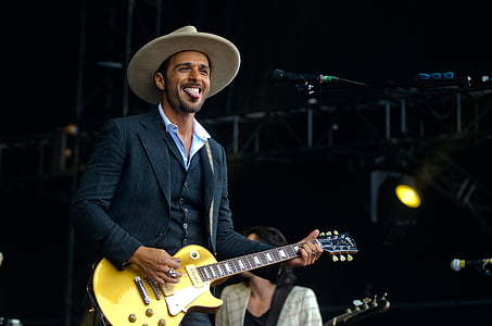 man sticking his tongue out while playing guitar thumbnail