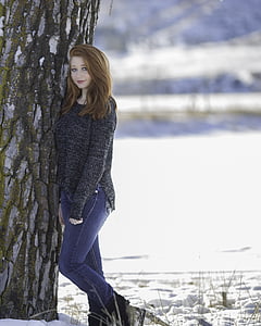 woman in black sweater beside tree in daytime thumbnail