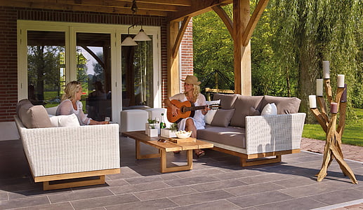 woman playing guitar sitting in front of woman in house at daytime thumbnail