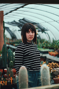 woman near cactus plant during daytime thumbnail