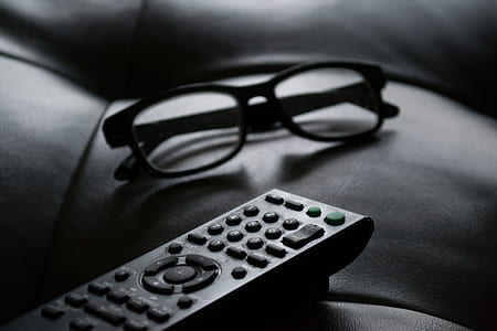 shallow focus photography of eyeglasses near remote thumbnail