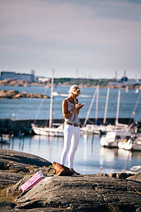 woman standing rock near sea thumbnail