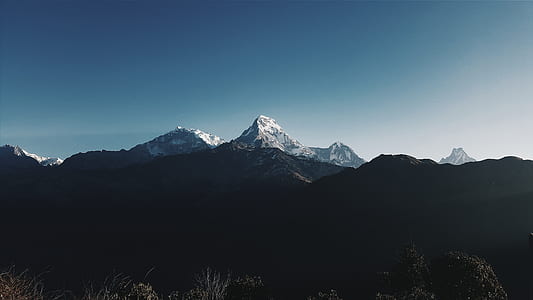 photo of mountain under blue sky background thumbnail