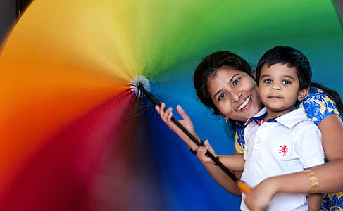 woman holding multicolored umbrella thumbnail