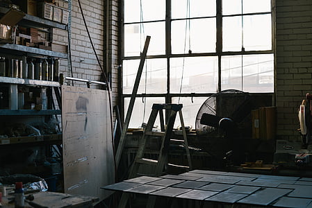 gray A-frame ladder beside pedestal fan near window thumbnail