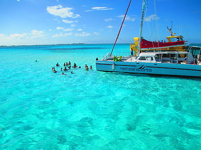 people swimming near white yacht during daytime thumbnail