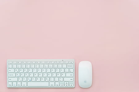 white Apple Magic Mouse and magic keyboard with pink background thumbnail