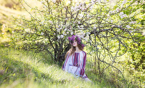 girl standing near white cherry blossom tree thumbnail