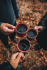three person holding red mugs thumbnail