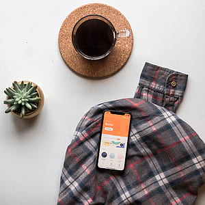 flat-lay photo of space gray iPhone x, coffee on brown coaster thumbnail