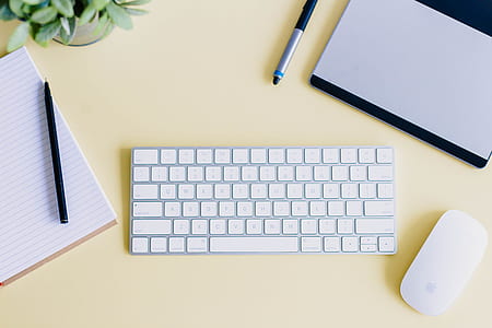 white Apple mouse near magic keyboard thumbnail