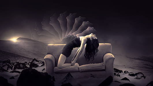 greyscale photography of woman in mini dress on grey fabric loveseat thumbnail