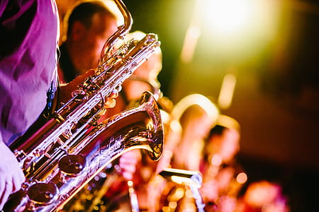 man playing brass-colored saxophone thumbnail